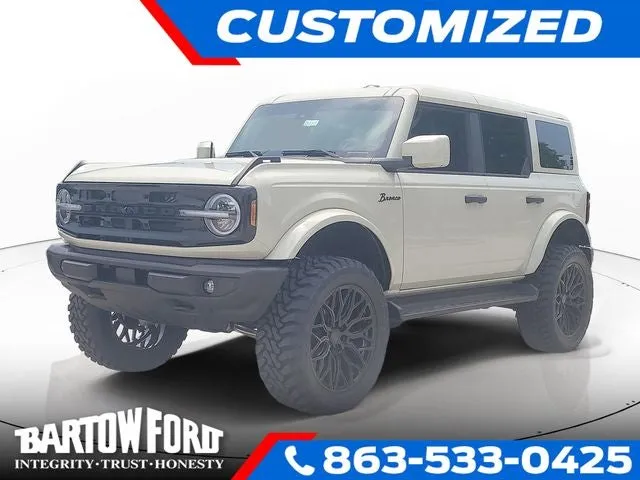 2026 Ford Bronco Outer Banks LIFTED / WHEELS & TIRES in Desert Sand — front three-quarter view