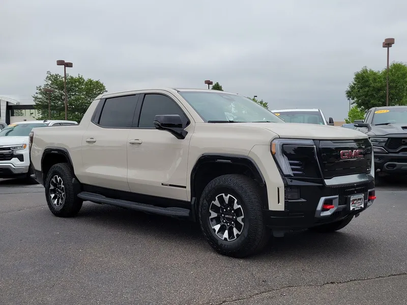 2026 GMC Sierra EV AT4 in Coastal Dune — front three-quarter view