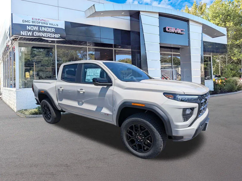 2026 GMC Canyon 4WD AT4 in Coastal Dune — front three-quarter view