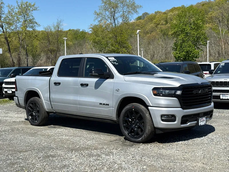 2026 RAM 1500 Laramie in Silver Zynith — front three-quarter view