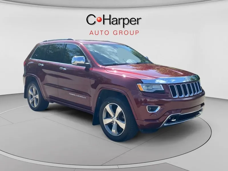 2016 Jeep Grand Cherokee Overland in Velvet Red Pearlcoat — front three-quarter view