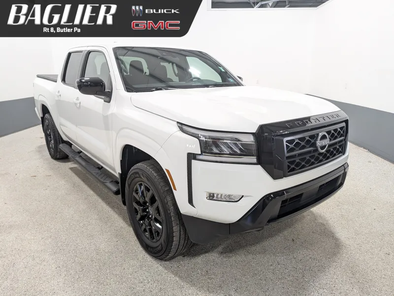 2023 Nissan Frontier Crew Cab SV 4x4 in White — front three-quarter view