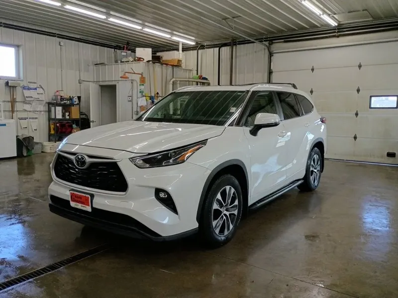 2023 Toyota Highlander L in White — front three-quarter view