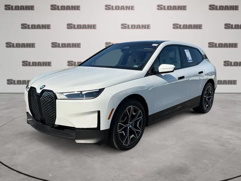 2024 BMW iX xDrive50 in Mineral White Metallic — front three-quarter view
