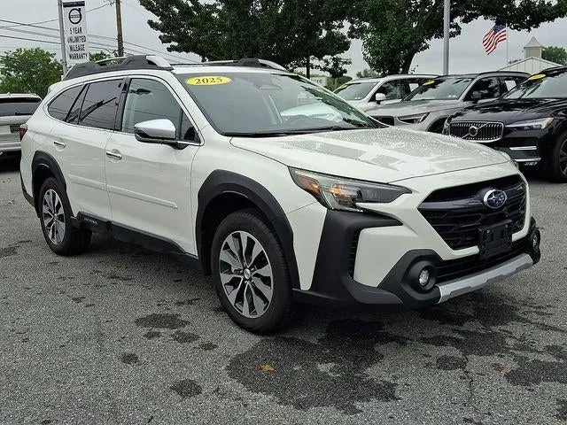 2025 Subaru Outback Touring AWD in Crystal White Pearl — front three-quarter view