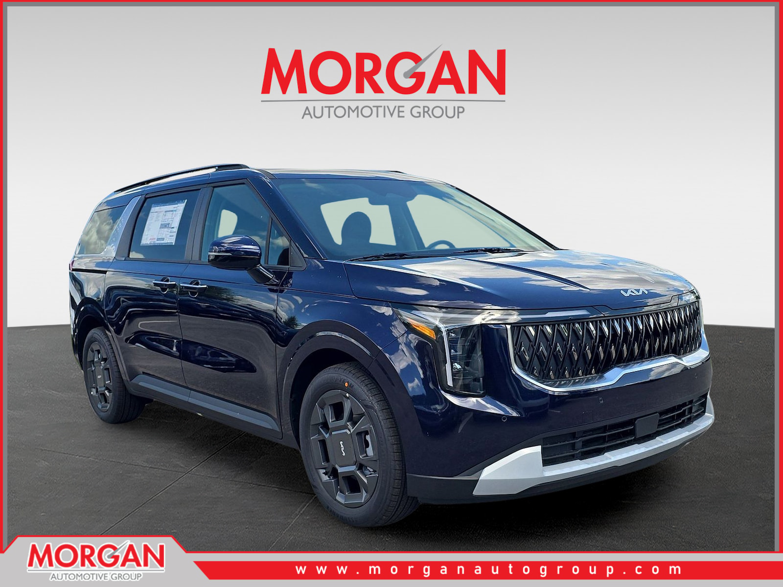 2026 Kia Carnival Hybrid EX in Deep Chroma Blue — front three-quarter view