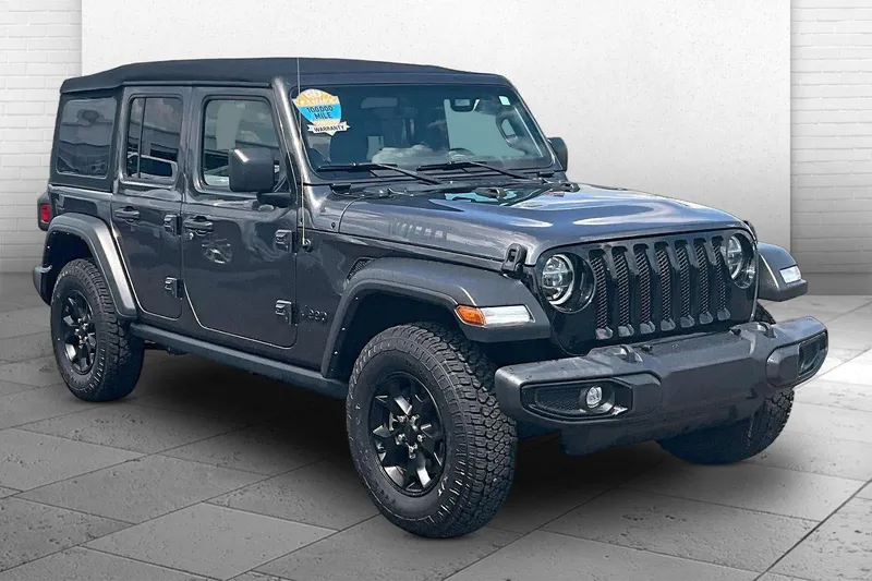 2022 Jeep Wrangler Unlimited Willys in Granite Crystal M — front three-quarter view