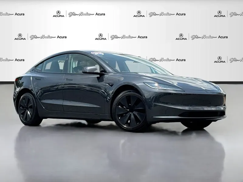 2025 Tesla Model 3 Long Range in Stealth Grey — front three-quarter view