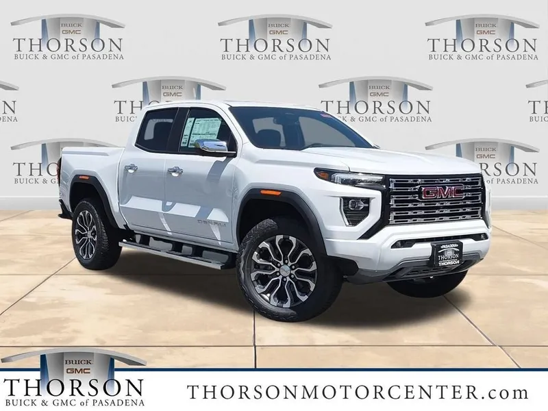 2026 GMC Canyon Denali in Summit White — front three-quarter view