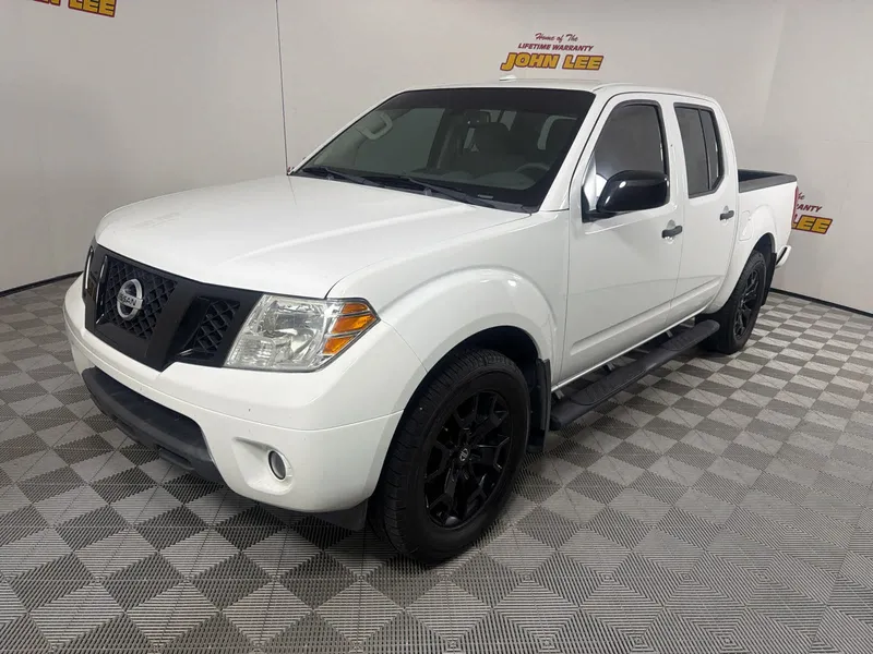 2018 Nissan Frontier SV V6 in Glacier White — front three-quarter view