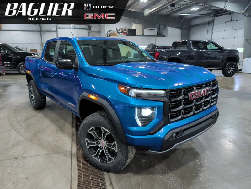 2023 GMC Canyon AT4 in Dynamic Blue Metallic — front three-quarter view