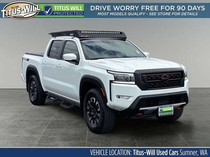 2023 Nissan Frontier PRO-4X in Glacier White — front three-quarter view