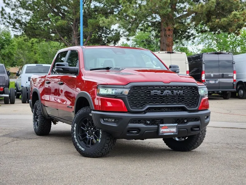 2026 RAM 1500 RAM 1500 REBEL CREW CAB 4X4 5'7' BOX in Molten Red Pearl-Coat Exterior Paint — front three-quarter view