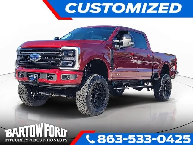 2026 Ford F-250SD Platinum 4WD CREW CAB / LIFT WHEELS & TIRES in Ruby Red Metallic — front three-quarter view