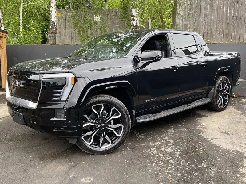 2025 GMC Sierra EV Max Range Denali in Onyx Black — front three-quarter view