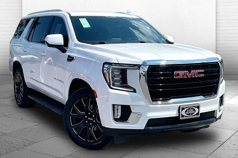 2023 GMC Yukon SLE in Summit White — front three-quarter view