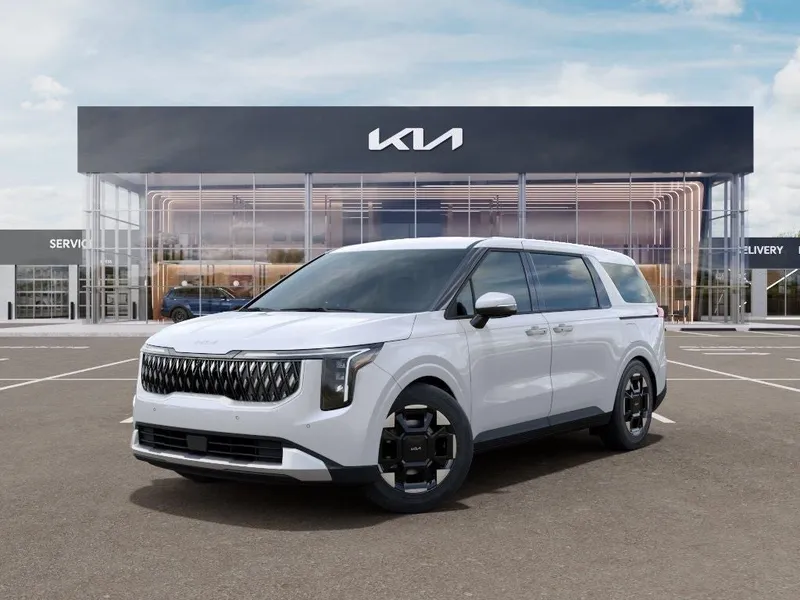 2026 Kia Carnival EX in Snow White Pearl — front three-quarter view