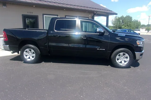 2023 RAM 1500 Laramie in Diamond Black Crystal Pearlcoat — front three-quarter view