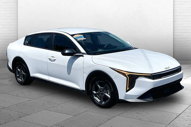 2025 Kia K4 LXS in Snow White Pearl — front three-quarter view
