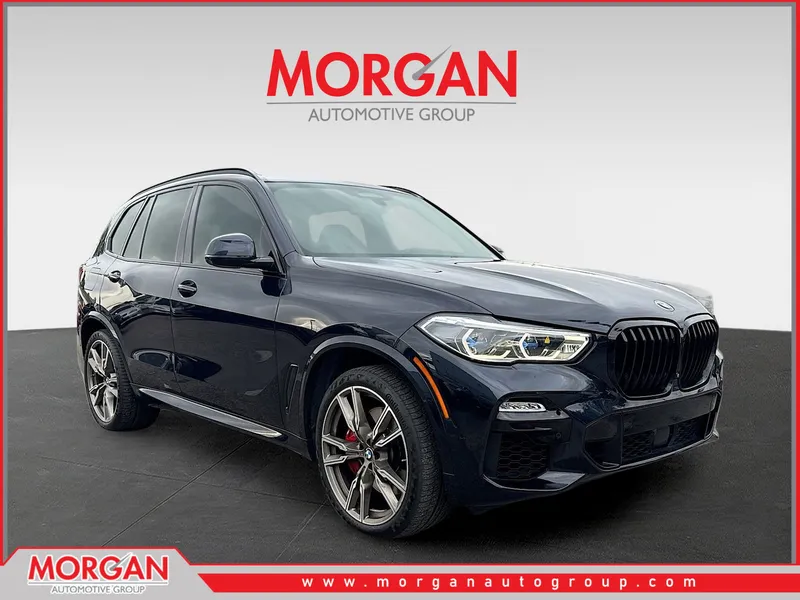 2021 BMW X5 M50i in Carbon Black Metallic — front three-quarter view