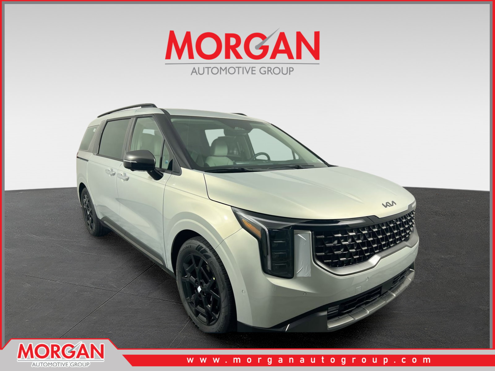 2026 Kia Carnival Hybrid SX in Ivory Silver — front three-quarter view
