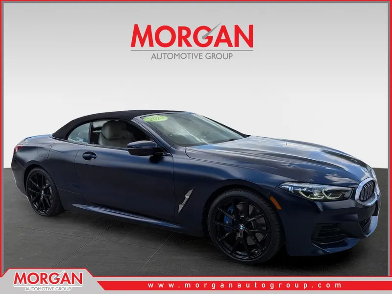 2023 BMW 8 Series 840i in Frozen Tanzanite Blue Metallic — front three-quarter view