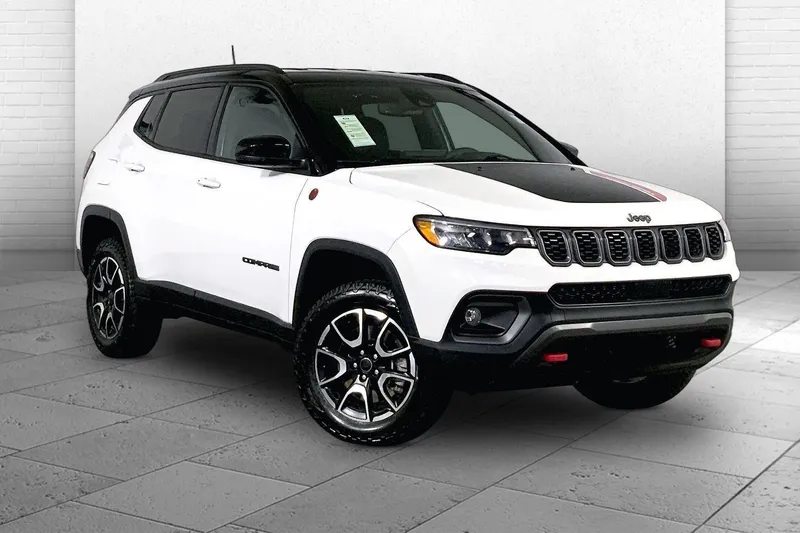2025 Jeep Compass Trailhawk in Bright White Clea — front three-quarter view
