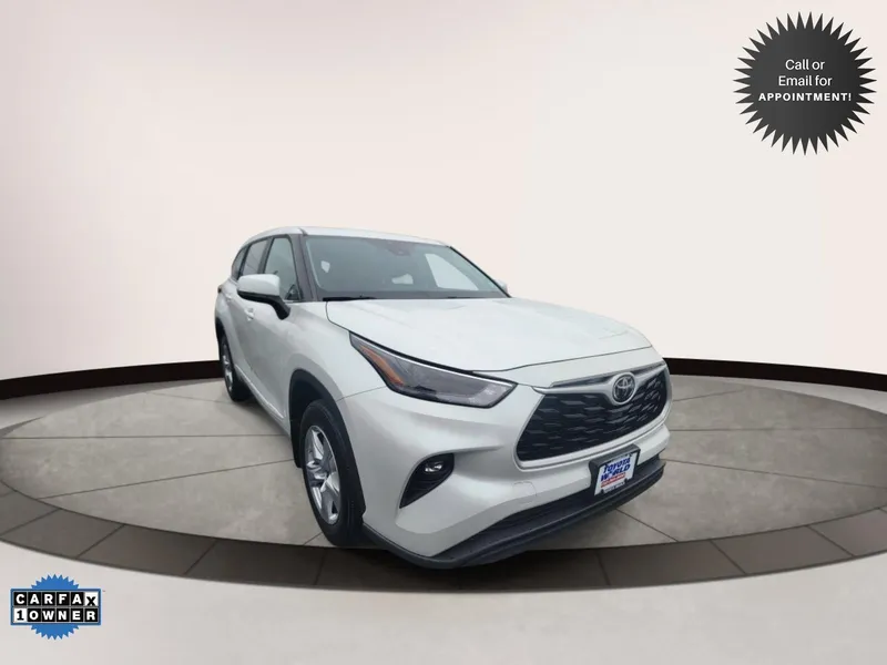 2023 Toyota Highlander LE in Beige — front three-quarter view
