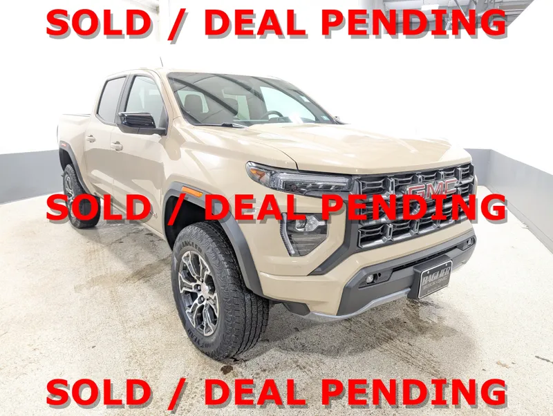 2023 GMC Canyon AT4 in Desert Sand Metallic — front three-quarter view