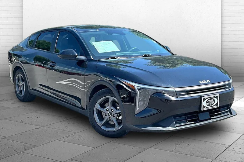 2025 Kia K4 LXS in Aurora Black Pear — front three-quarter view