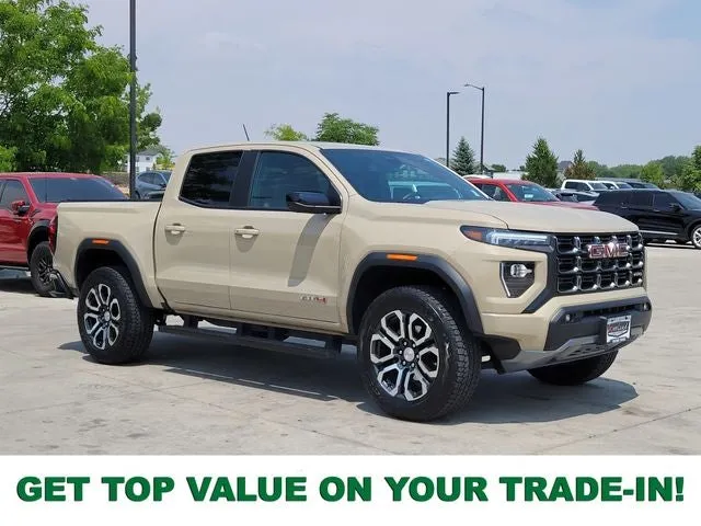 2024 GMC Canyon AT4 in Desert Sand Metallic — front three-quarter view