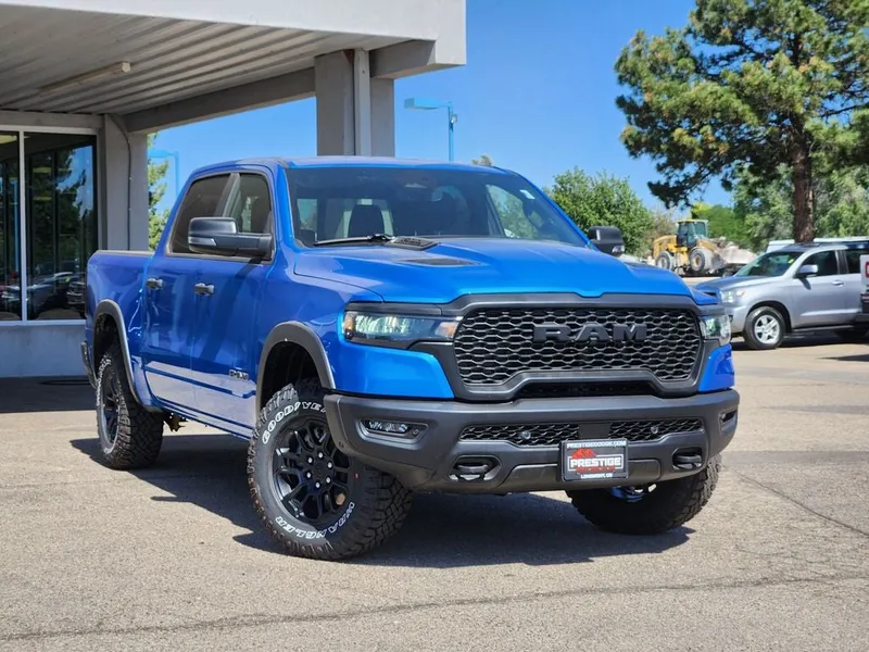 2026 RAM 1500 RAM 1500 REBEL CREW CAB 4X4 5'7' BOX in Hydro Blue Pearl-Coat Exterior Paint — front three-quarter view