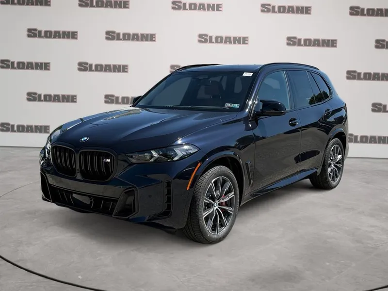 2026 BMW X5 M60i in Carbon Black Metallic — front three-quarter view