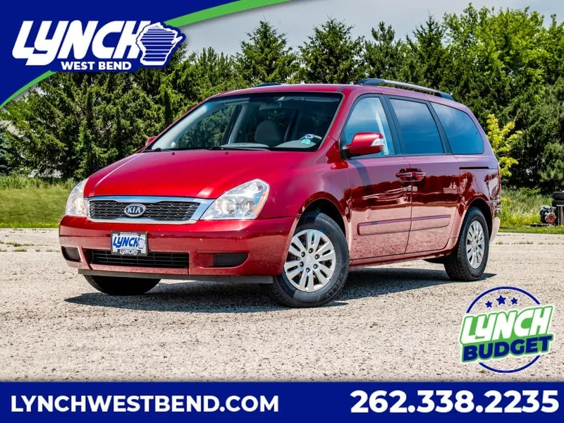 2012 Kia Sedona LX in Red — front three-quarter view