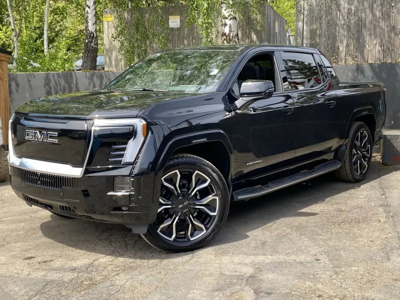 2025 GMC Sierra EV Max Range Denali in Onyx Black — front three-quarter view
