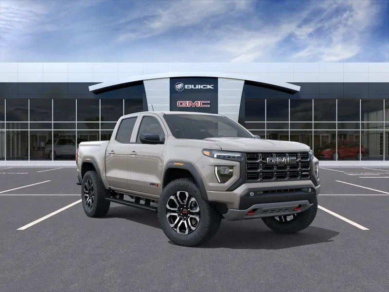 2026 GMC Canyon AT4 in Coastal Dune — front three-quarter view