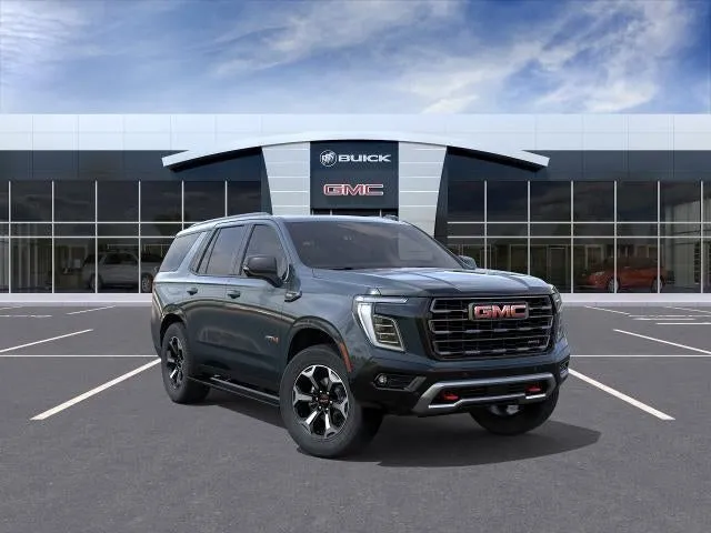 2026 GMC Yukon AT4 Ultimate in Midnight Pine — front three-quarter view