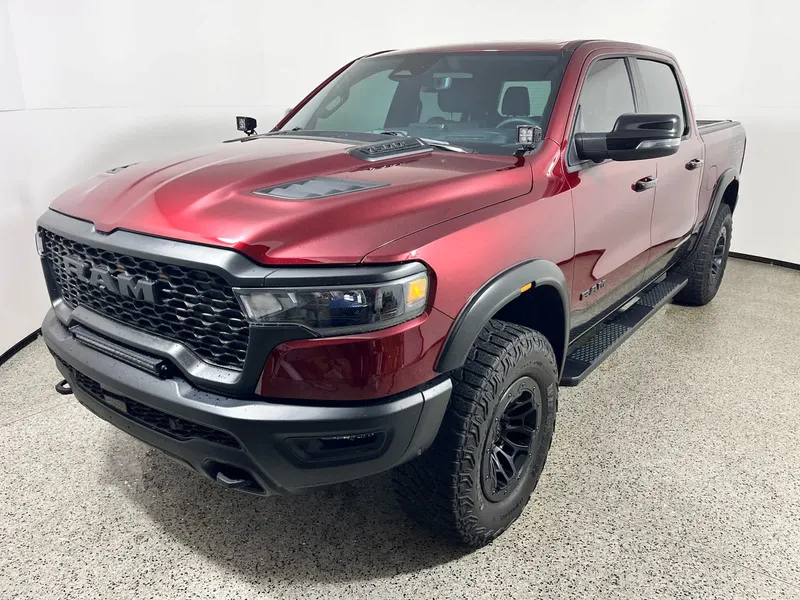 2025 RAM 1500 Rebel in Delmonico Red Pearlcoat — front three-quarter view