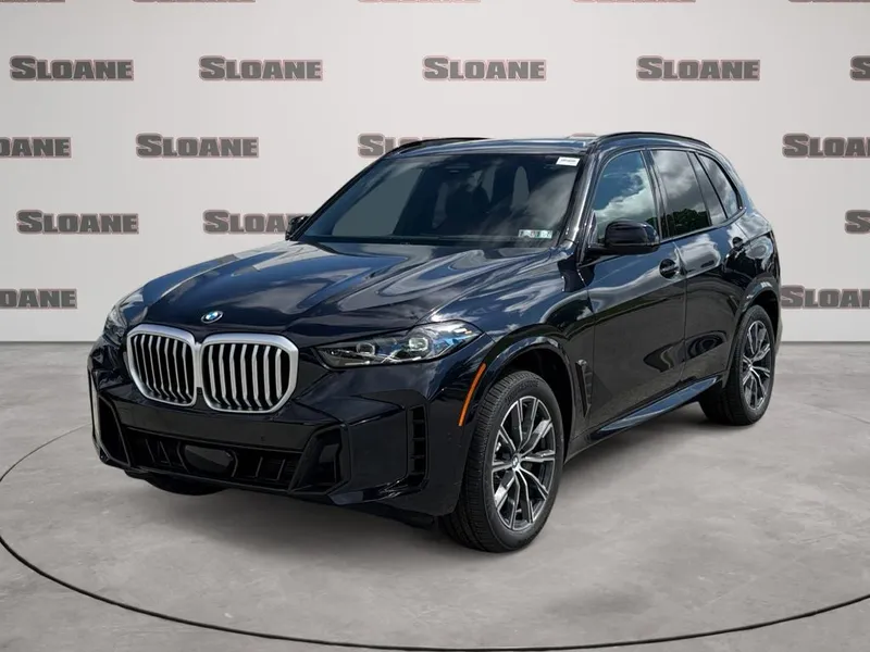 2026 BMW X5 xDrive40i in Carbon Black Metallic — front three-quarter view