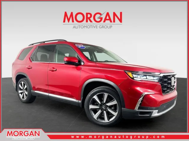 2025 Honda Pilot Touring in Red — front three-quarter view