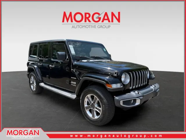 2021 Jeep Wrangler Unlimited Sahara in Black — front three-quarter view