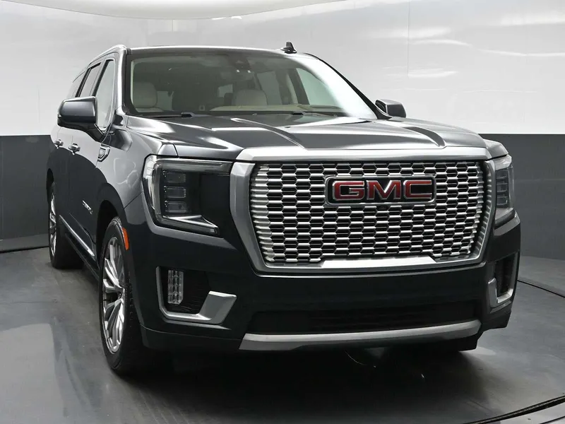 2021 GMC Yukon Denali in Hunter Metallic — front three-quarter view