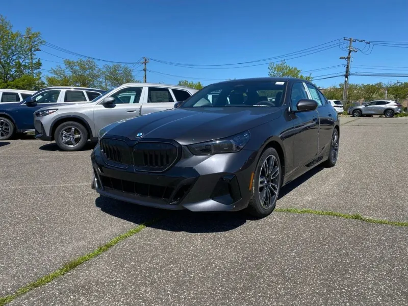 2027 BMW 5 Series 540i xDrive in Dark Graphite Metallic — front three-quarter view