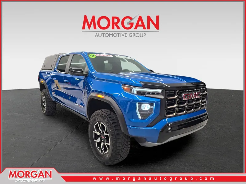 2024 GMC Canyon 4WD AT4X in Dynamic Blue Metallic — front three-quarter view
