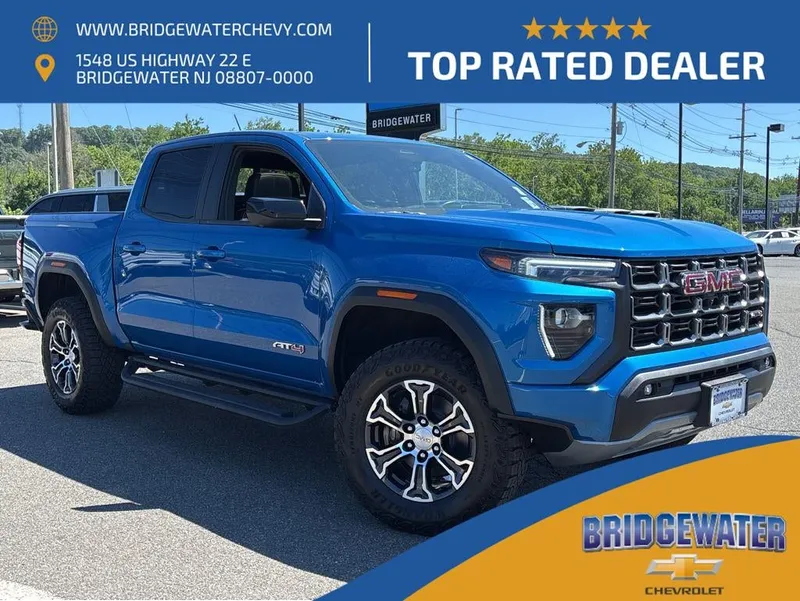 2023 GMC Canyon AT4 in Dynamic Blue Metallic — front three-quarter view