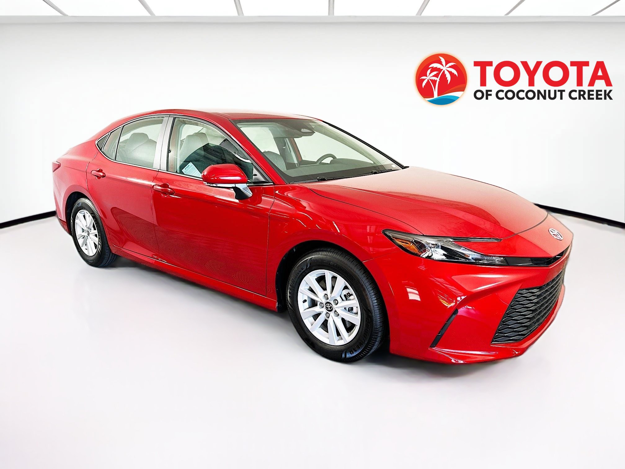 2026 Toyota Camry LE in Red — front three-quarter view