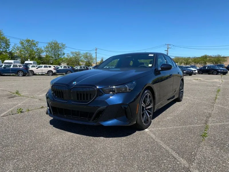 2027 BMW 5 Series 550e xDrive in Carbon Black Metallic — front three-quarter view