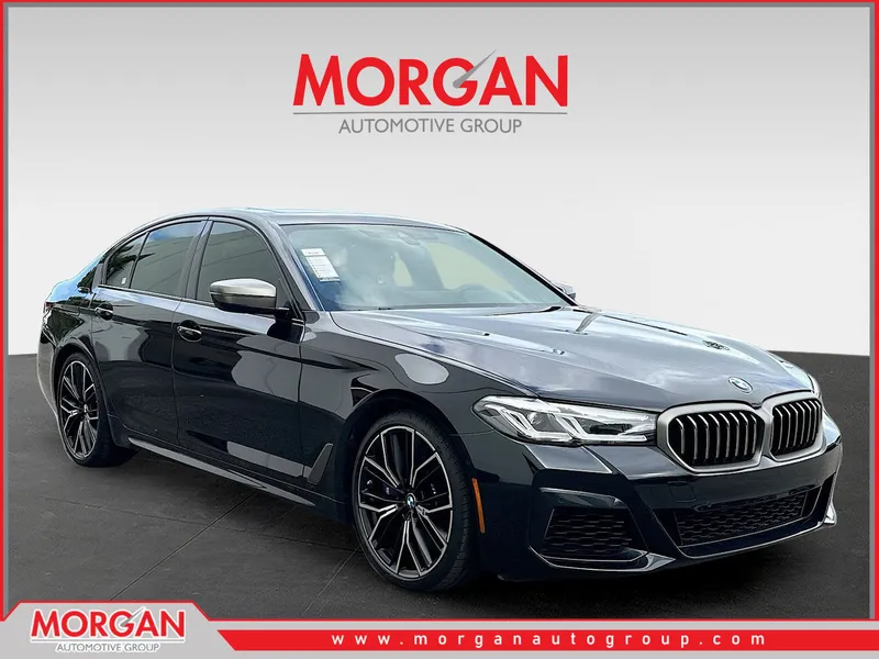 2023 BMW 5 Series M550i xDrive in Black Sapphire Metallic — front three-quarter view
