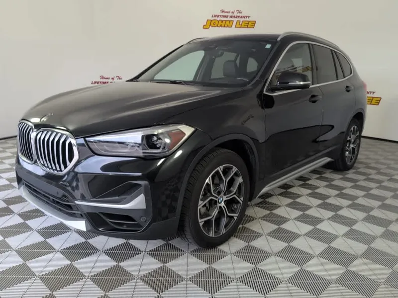 2021 BMW X1 sDrive28i in Black Sapphire Metallic — front three-quarter view