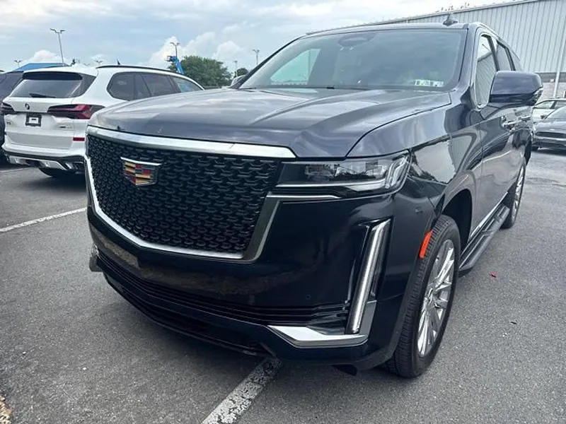 2023 Cadillac Escalade 4WD Premium Luxury in Dark Moon Blue Metallic — front three-quarter view